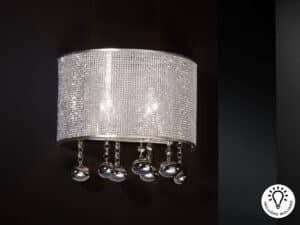 Andromeda wall light placed on a wall with a black background