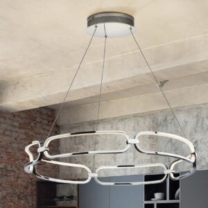 image shows an led pendant light hanging in a room with bare brick walls
